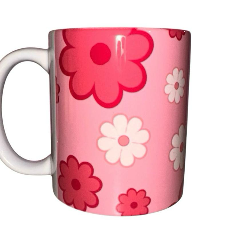 ASKMOL Pink floral pattern ceramic coffee mug with white handle. Features pink and white flowers.