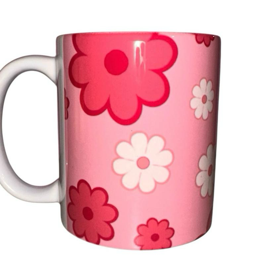ASKMOL Pink floral pattern ceramic coffee mug with white handle. Features pink and white flowers.